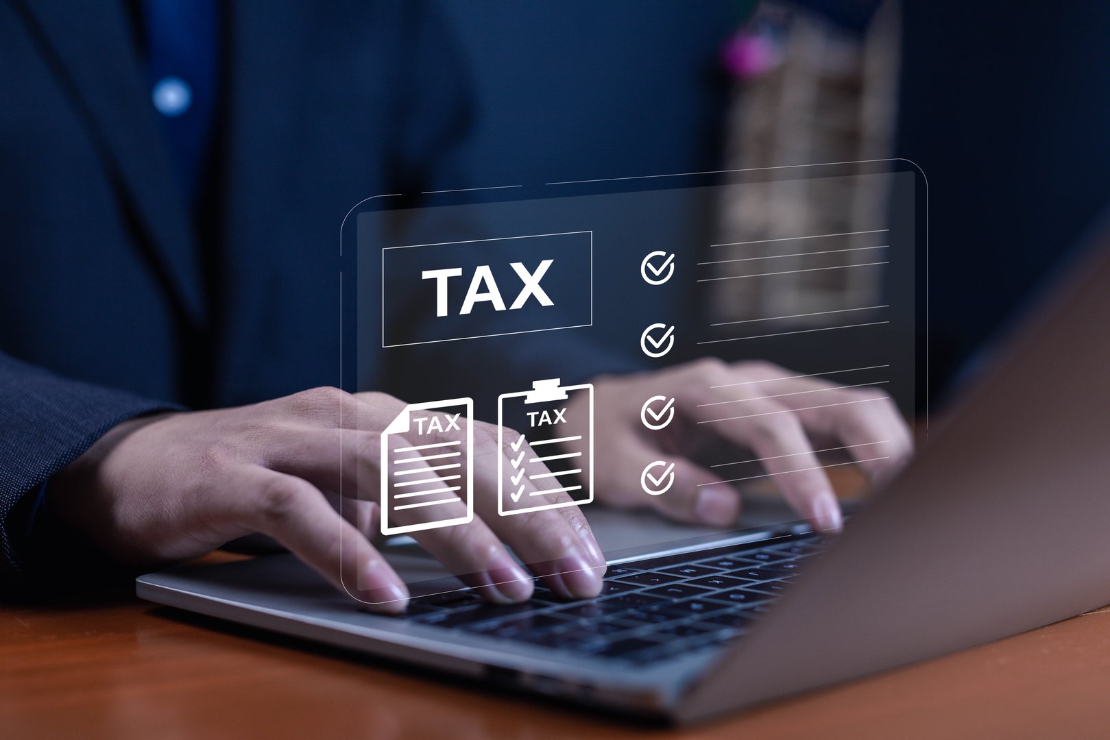 Businessman typing on laptop with digital tax documents and checklist icons, concept of online tax filing, finance, accounting, digital government service, business management, and compliance.