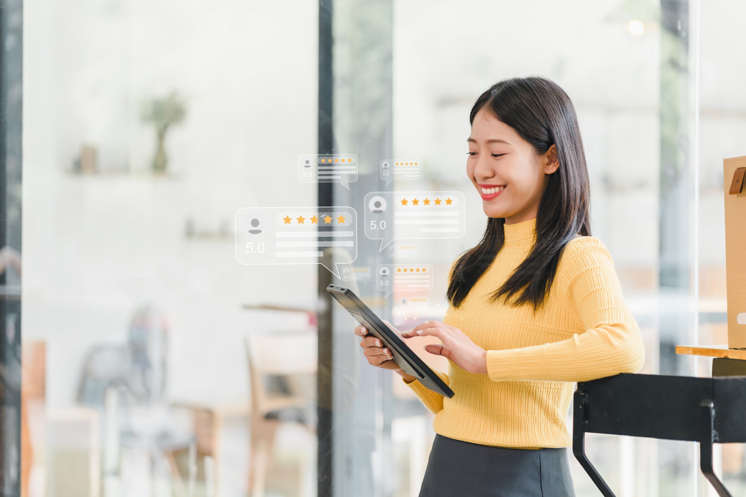 young woman in yellow sweater is smiling while using tablet, surrounded by digital review icons indicating high ratings. This scene captures essence of customer satisfaction and modern technology.