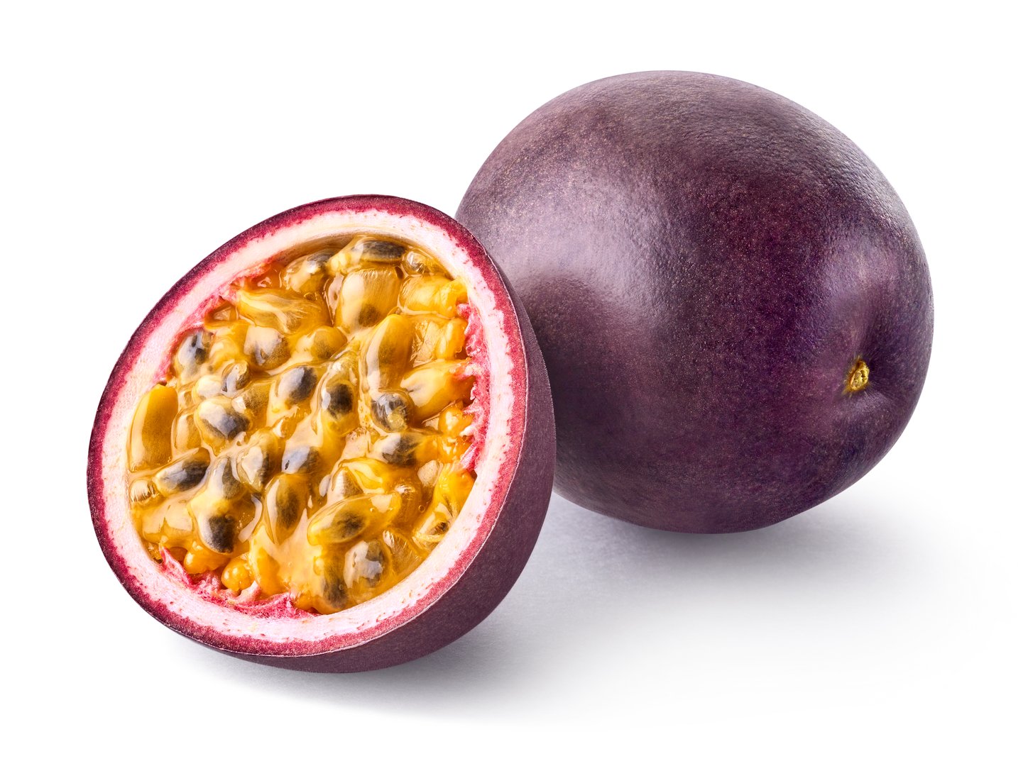 Whole and half fresh ripe passion fruit isolated on white background