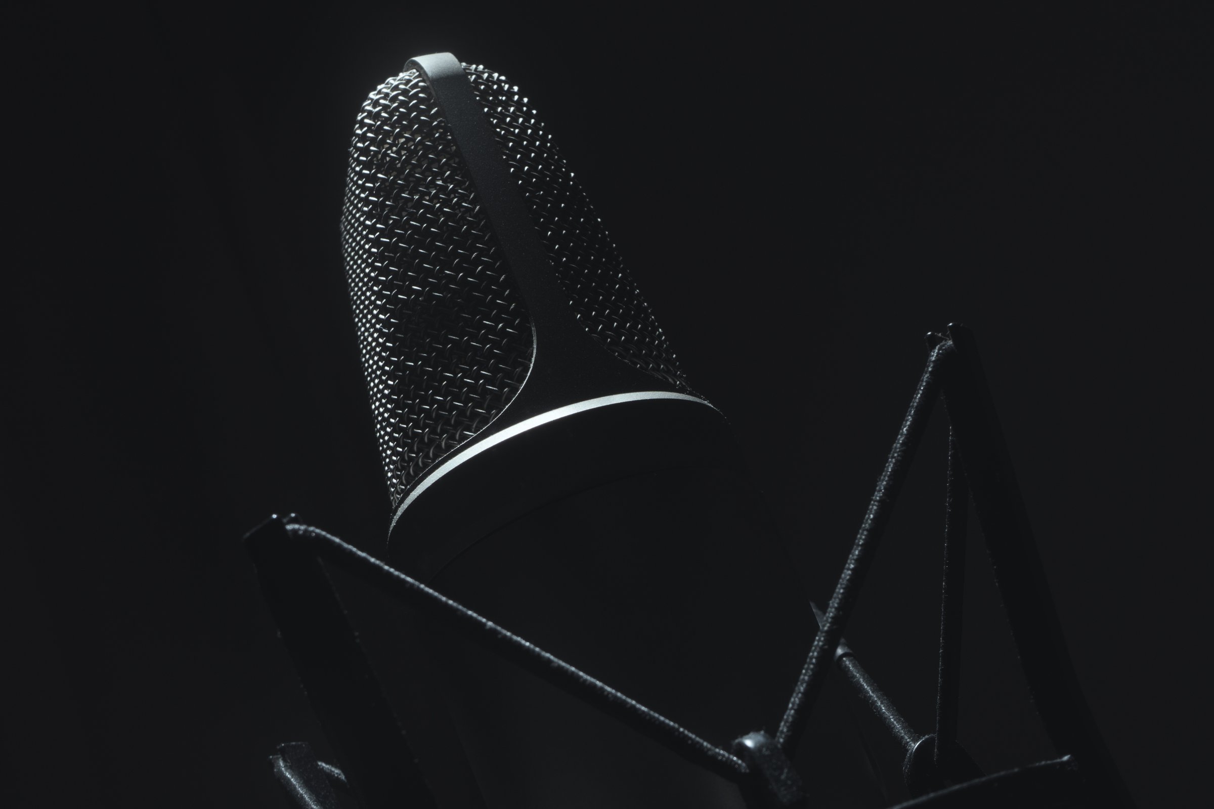 Large diaphragm condenser studio microphone close-up on dark background. Studio Equipment. Music Industry