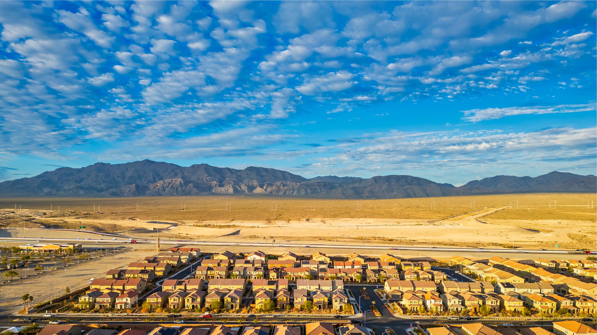 An aerial shot of Las Vegas suburb with tightly packed houses and red-tiled roofs