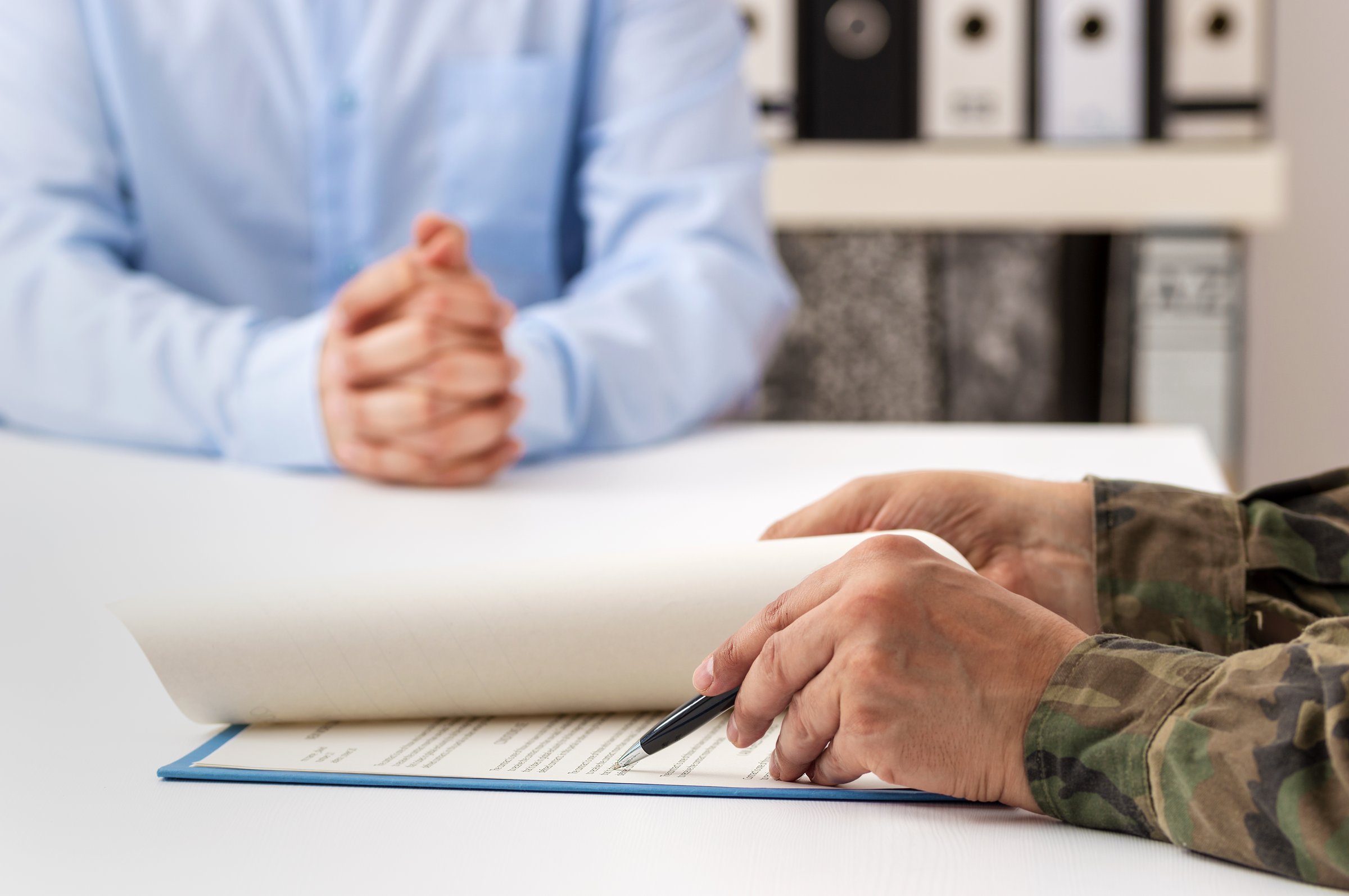 Man organizing military application documents