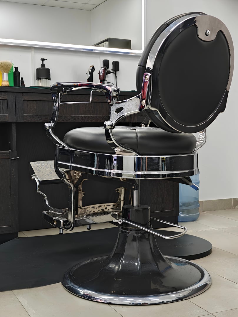 Black vintage barber chair. Hair salon.