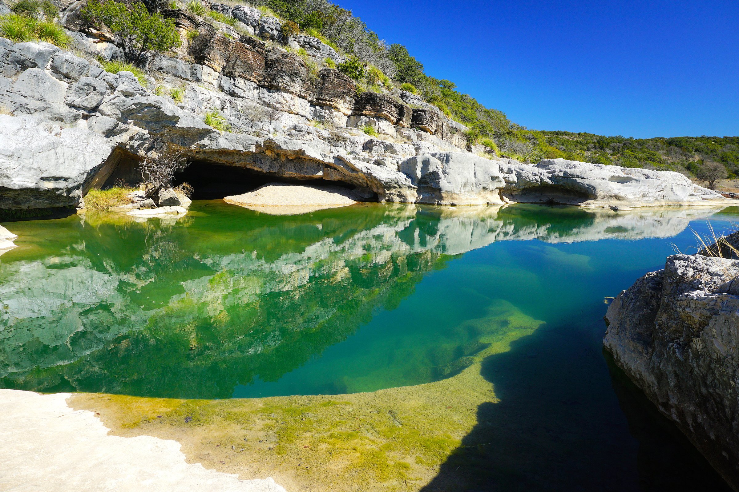 The Pedernales River flows, erodes, and channels through Hill Country Limestone creating dramatic pools, falls, and springs at Pedernales Falls State Park near Austin Texas in  Travis County