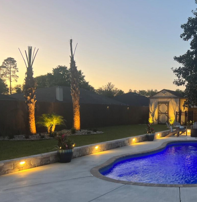 Landscape lighting illuminating pool area