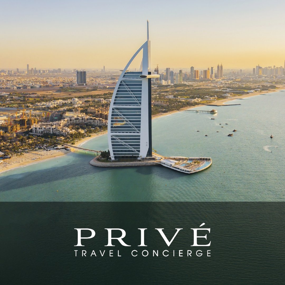 Aerial view of Burj Al Arab in Dubai with the text Privé Travel Concierge overlayed at the bottom.