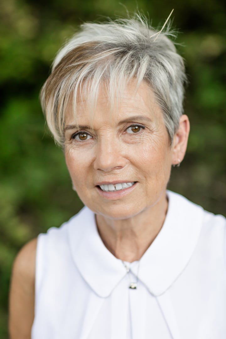 Portrait of happy and smiling senior woman taking a walk in the countryside