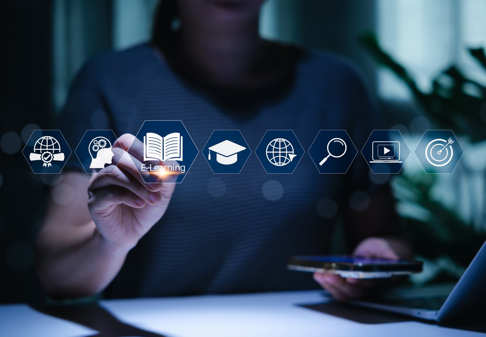 Online education and e-learning technology concept. Person interacts with icons represent e-learning, education, content, and online courses, modern technology for remote and digital education systems