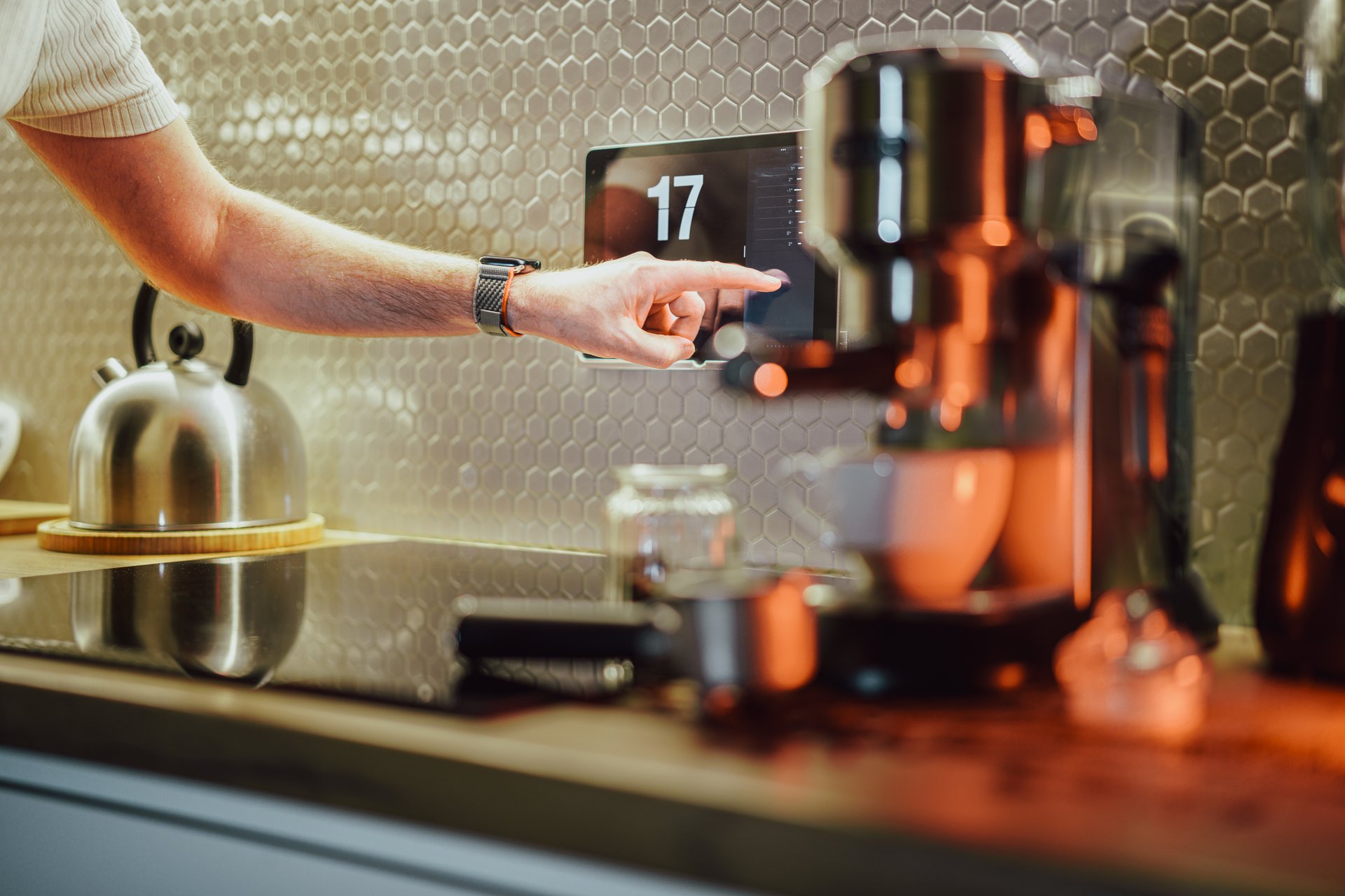 Smart home. Touch screen operation in a modern kitchen. Coffe machine. Home automation.  A hand operating a touch screen.