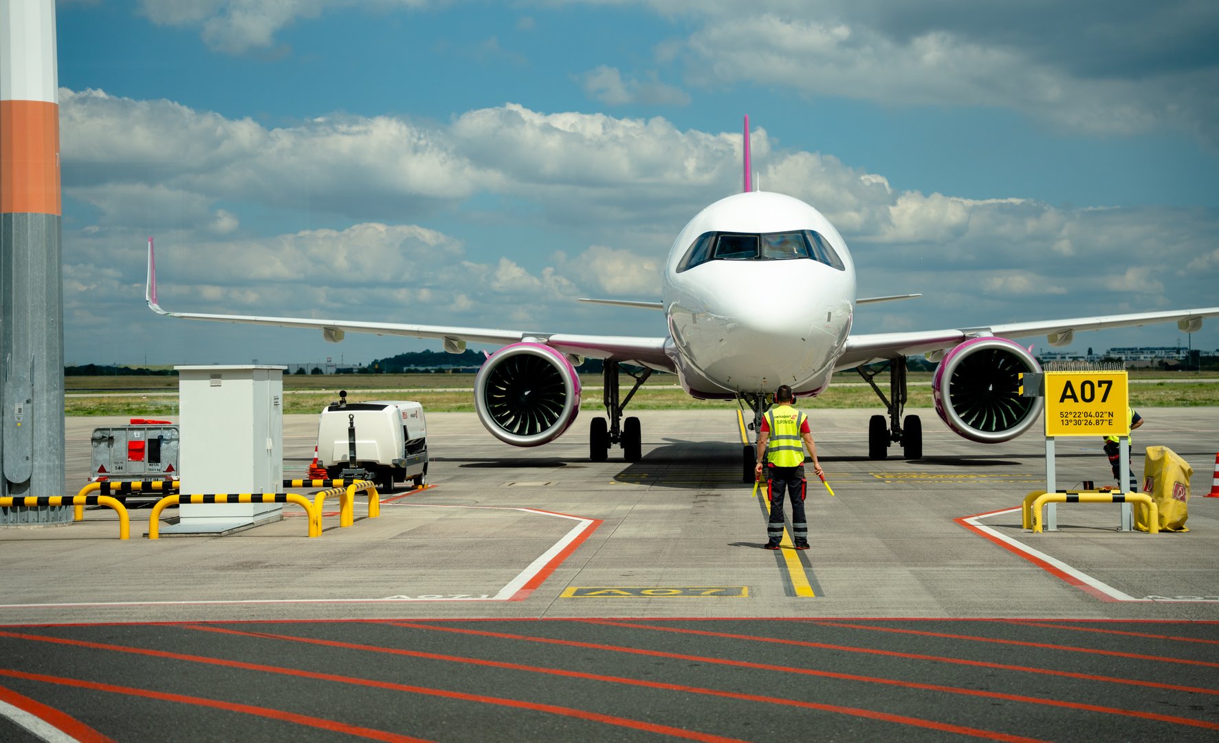 Berlin, Germany - June 24, 2024: Parking a Plane: The Delicate Dance Between Pilot and Ground Handler