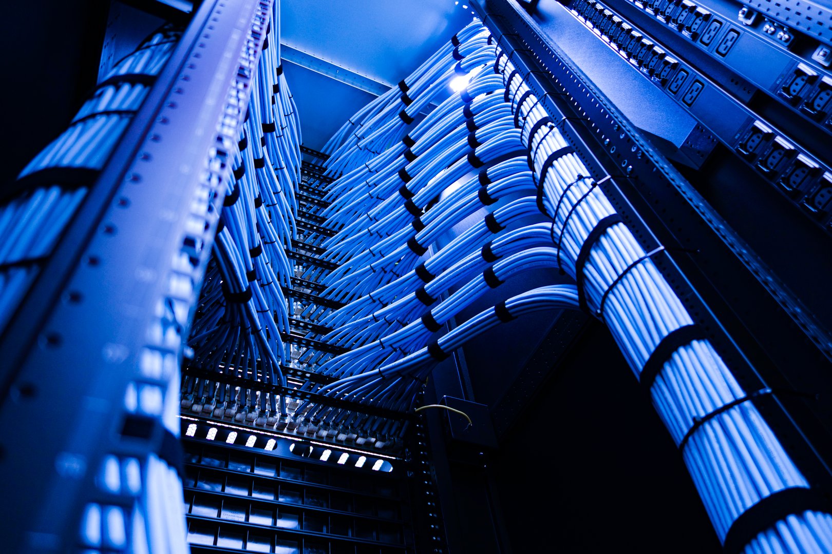 Detailed view of a modern data center showcasing organized cables and high-tech servers, highlighting the importance of connectivity and performance in technology infrastructure.