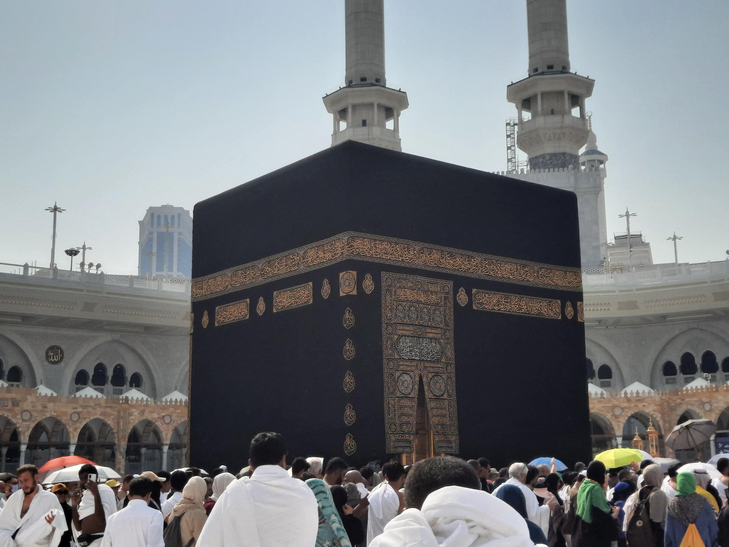 A beautiful view of the Grand Mosque's inner courtyard in Makkah during the day.  Pilgrims from all over the world are circumambulating the Kaaba.