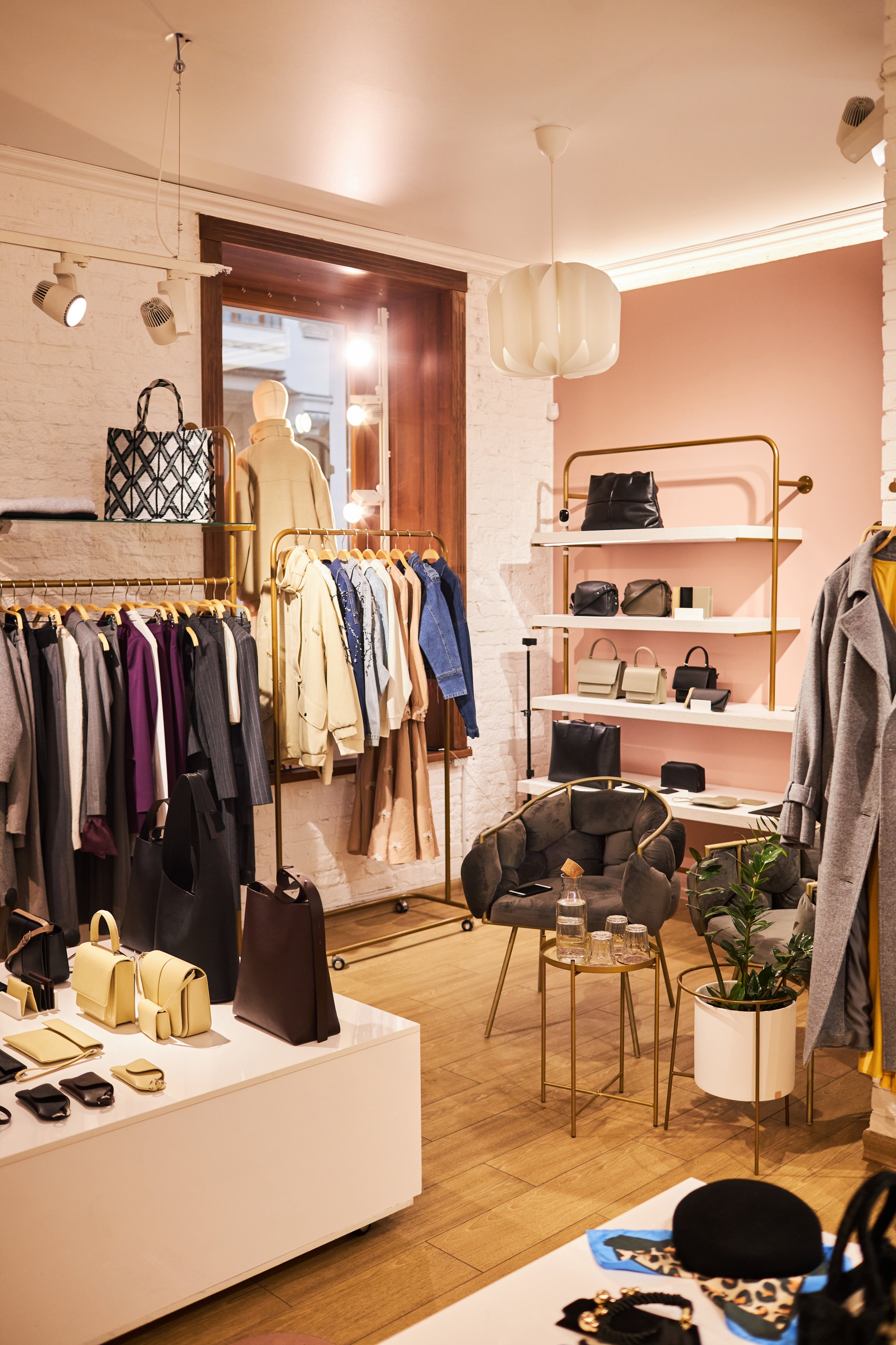 Vertical background image of empty clothing boutique interior with clothes and accessories, copy space