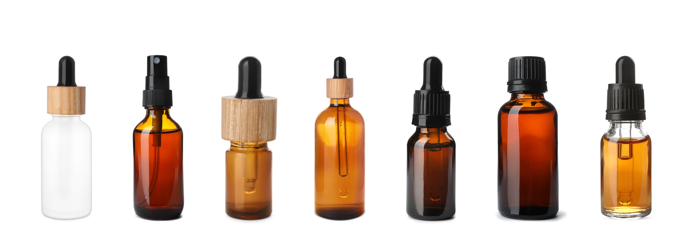 Set of different cosmetic oils in bottles on white background
