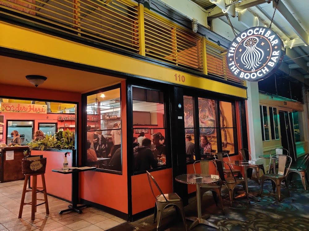 Vibrant interior of The Booch Bar in Hilo featuring kombucha on tap and colorful plant-based menu