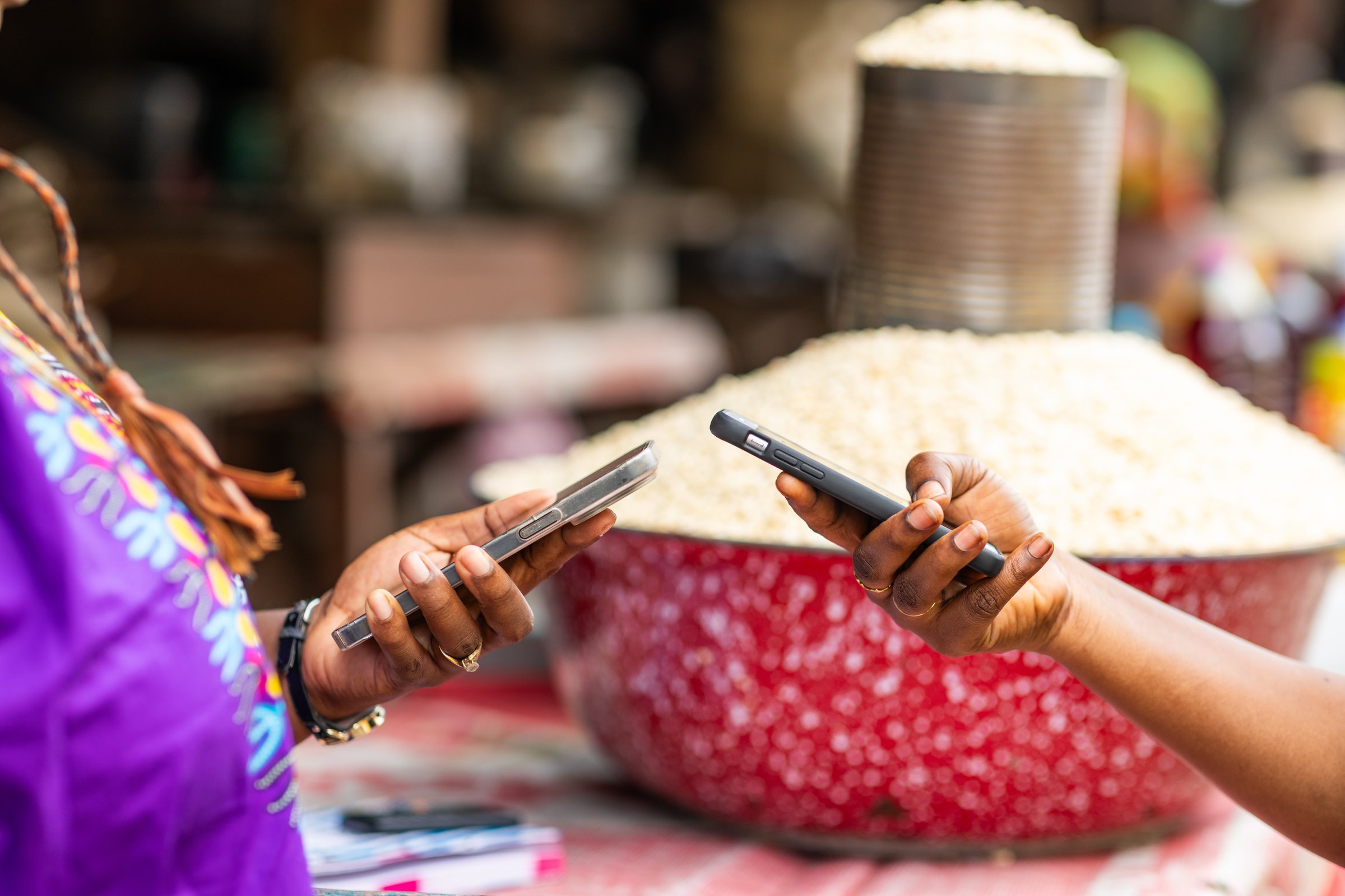 Digital mobile money payment for fresh grains at African local outdoor market