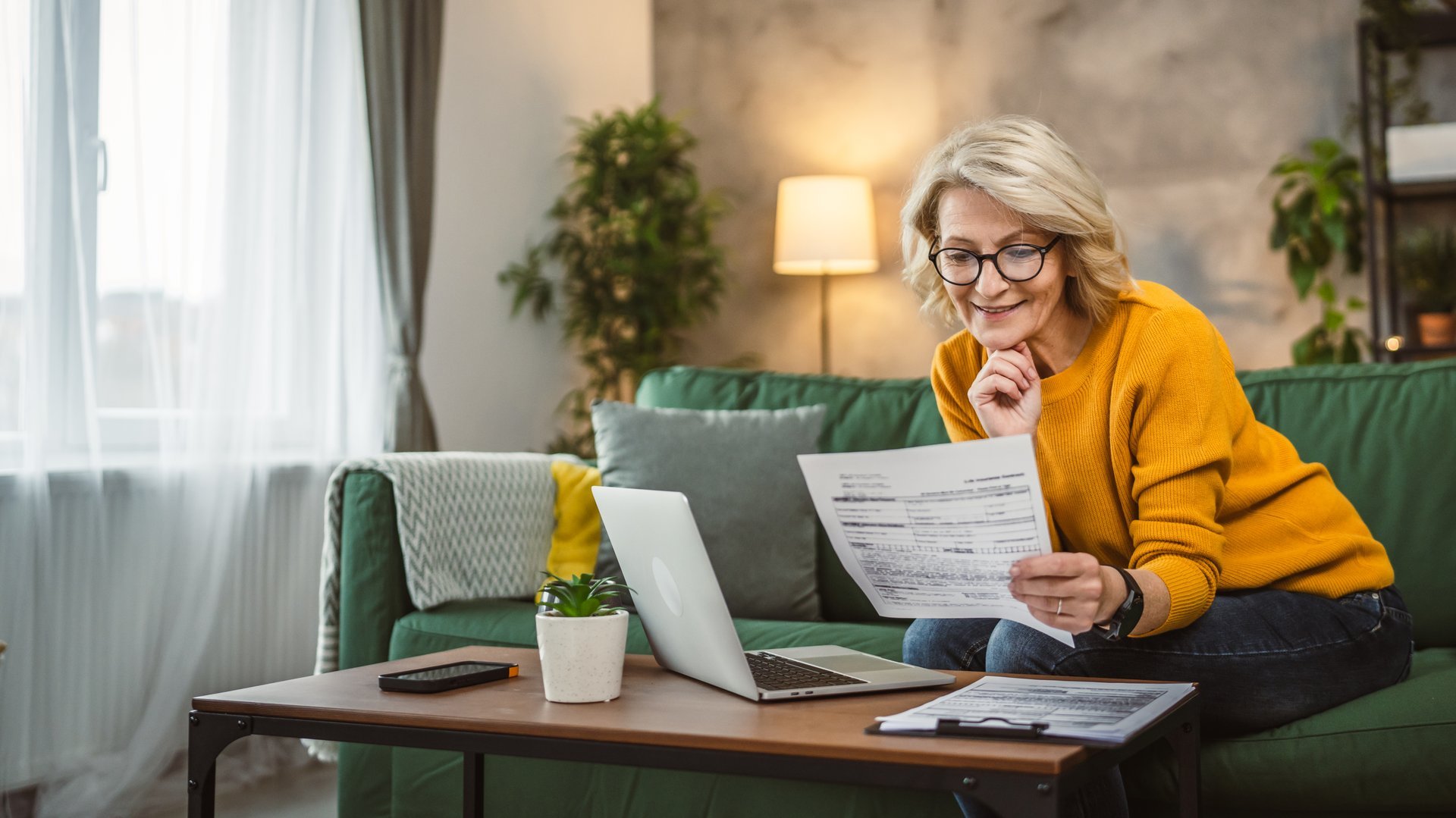 mature caucasian woman use laptop computer at home for work on project