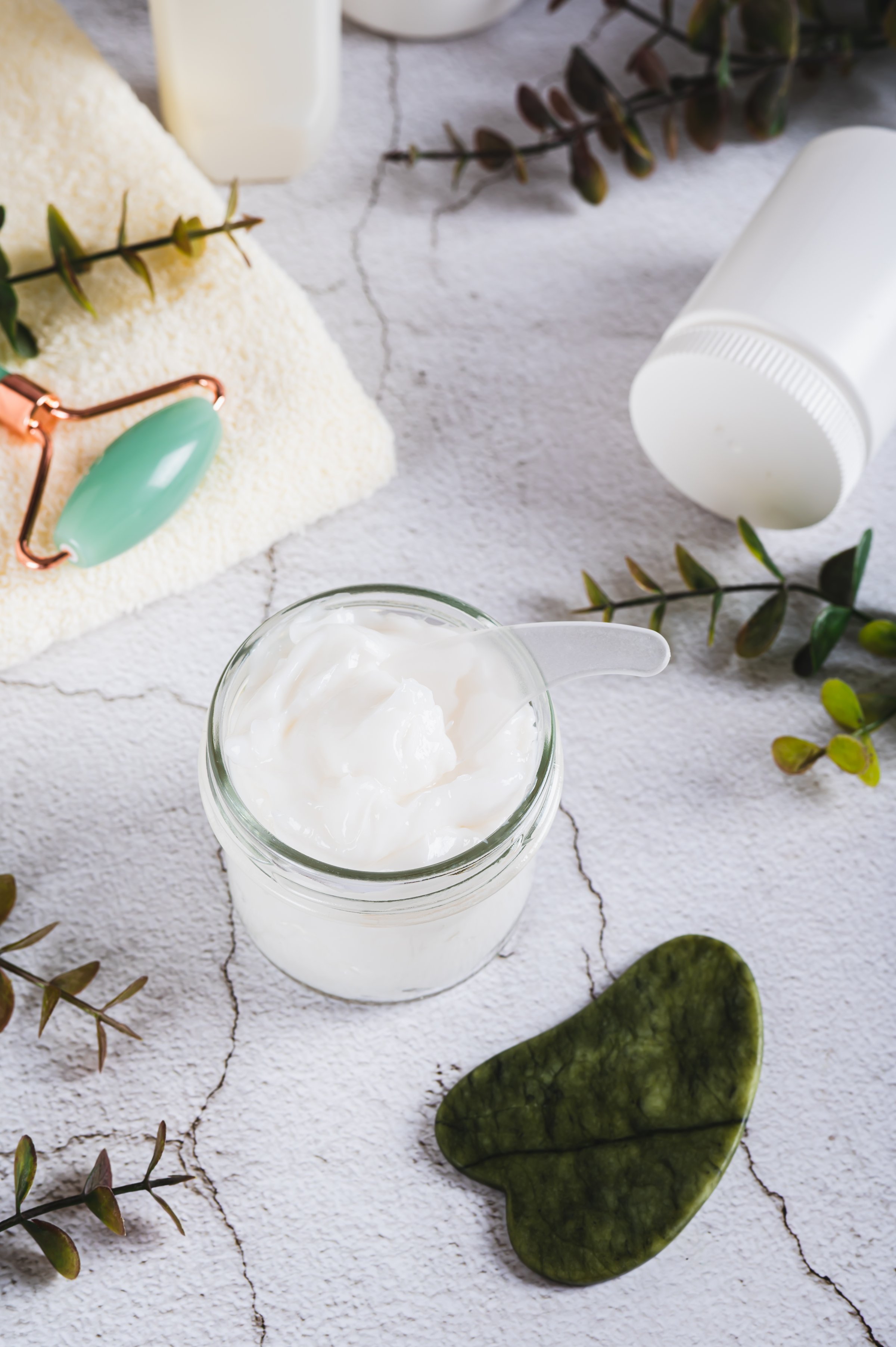 Moisturizing cream with beef tallow in a jar on the table vertical view