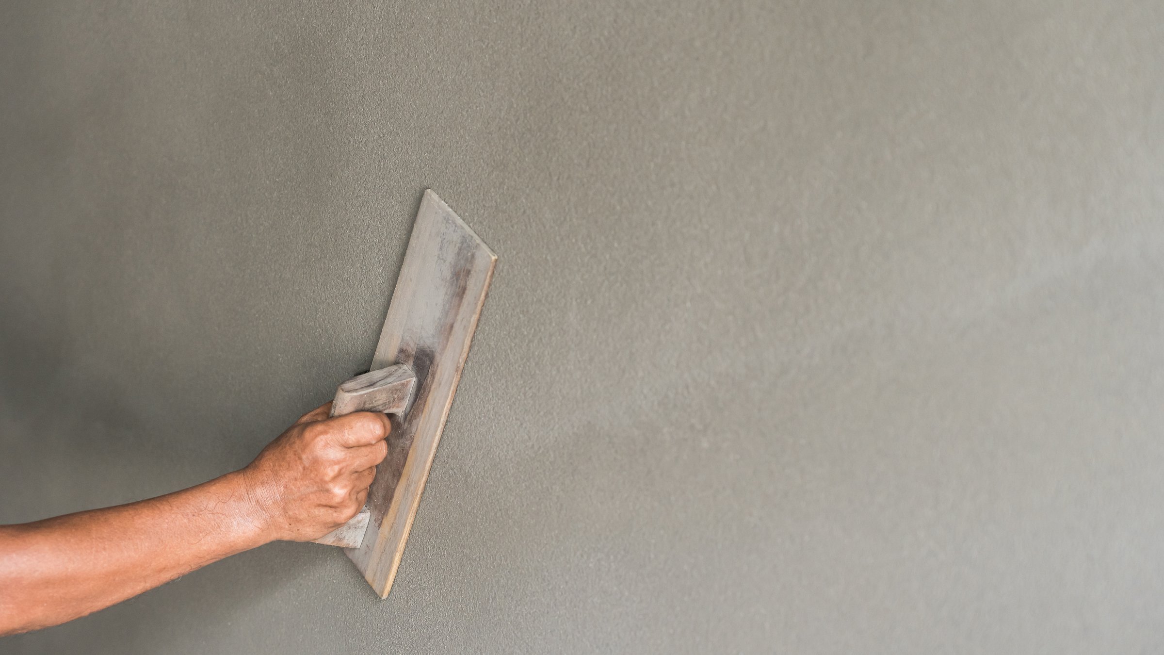 Cement wall, Hand worker Plastering wet Cement Background with handle brush trowel, Manual men handwork polish concrete floor rough texture decorated loft surface well free space for text presentation