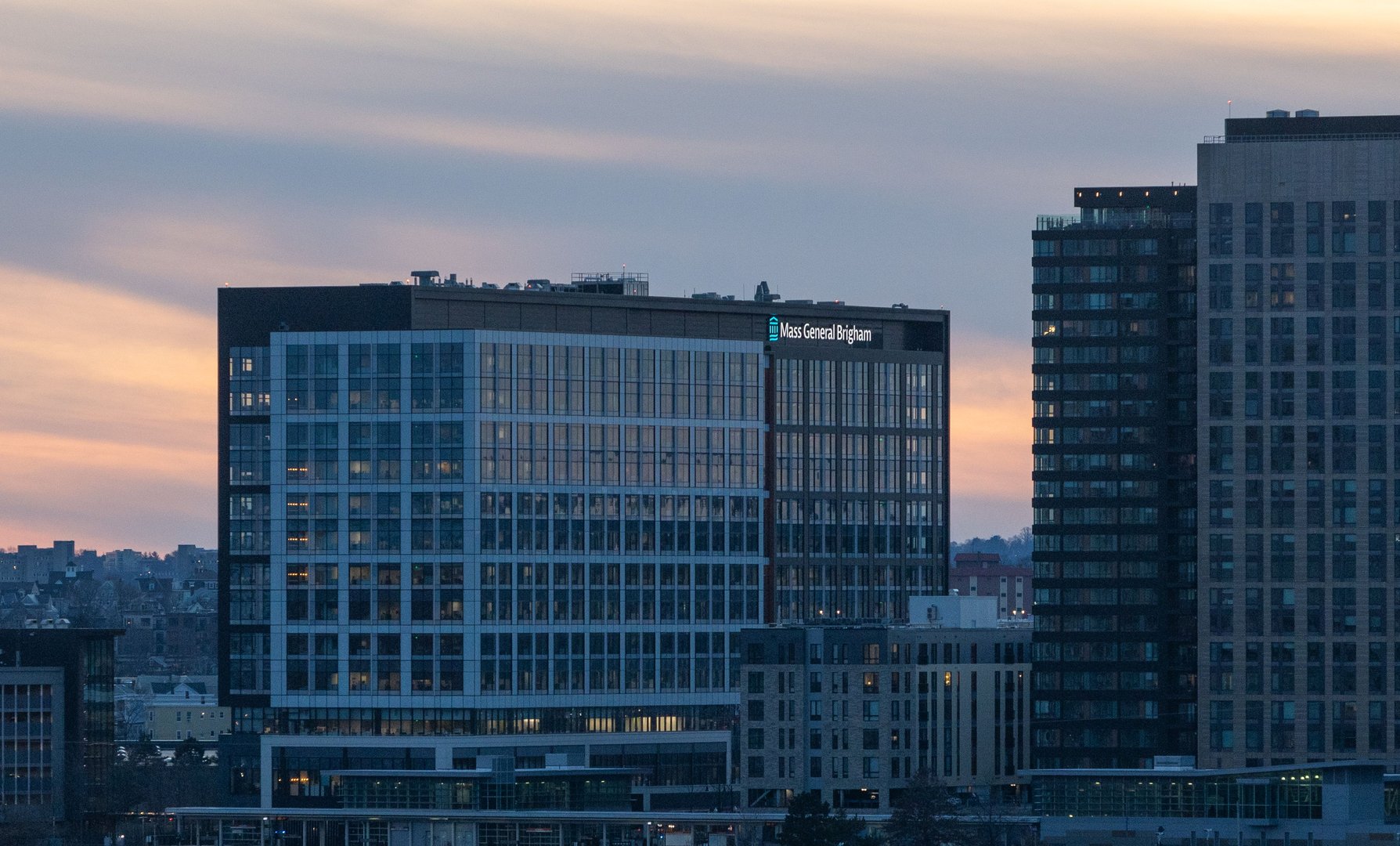 Somerville, United States – October 15, 2024: Mass General Brigham headquarters at sunset in Somerville, Massachusetts, surrounded by buildings