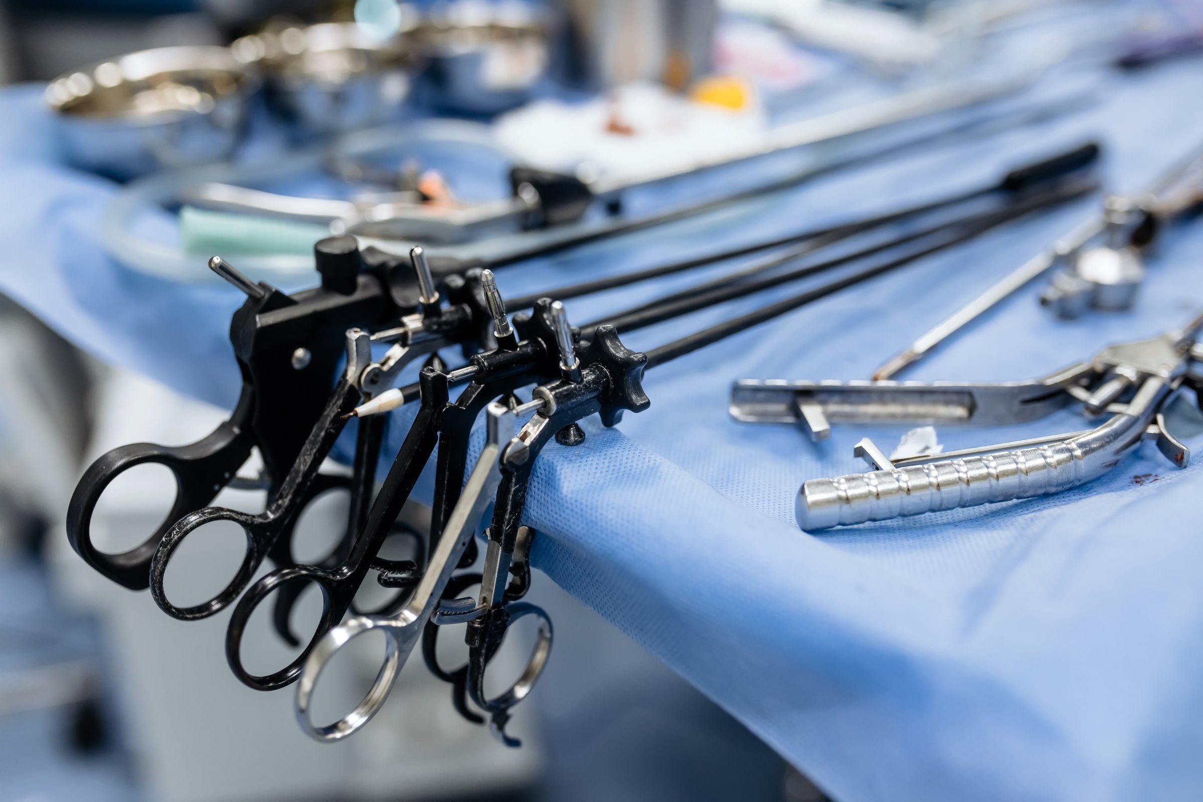 A group of medical surgeons in the operating room during an operation. A patient on the operating table during laparoscopic abdominal surgery. The concept of modern medical equipment.