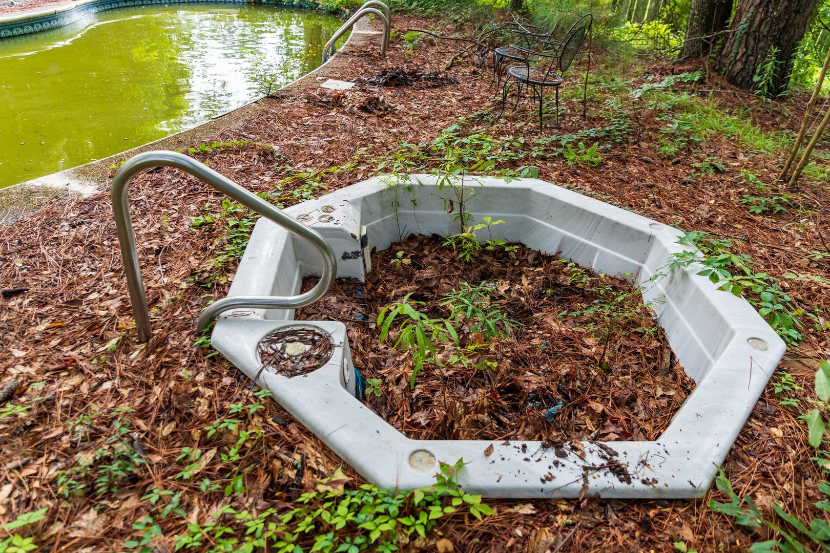 Backyard pool and hot tub in ruins