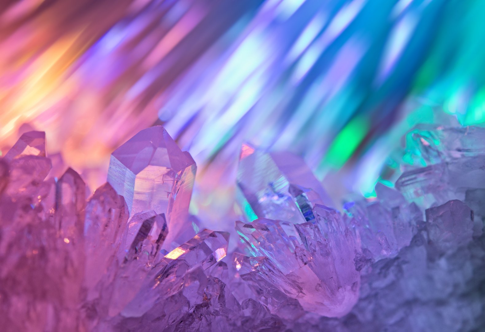 Sparkling multi-colored background with rays of light and crystals of rock crystal.