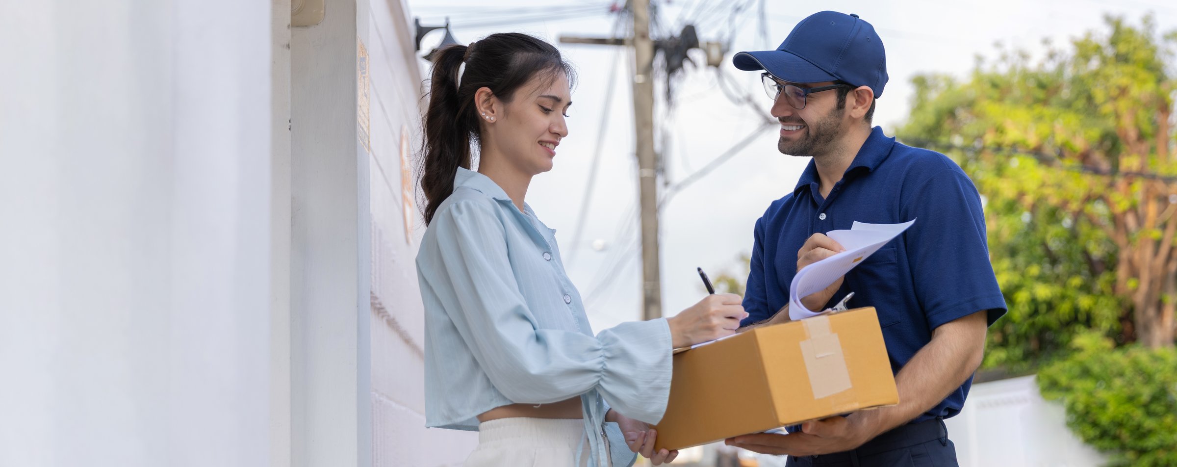 Delivery express courier young man use giving boxes or Food to woman customer  at front home. Woman receiving a food delivery order in a brown paper bag or Box at her home