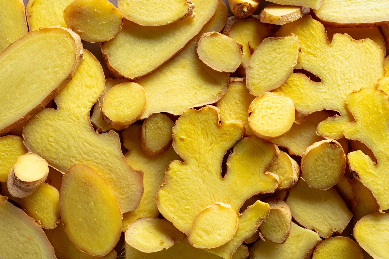 Close-up of fresh ginger slices. Top view.