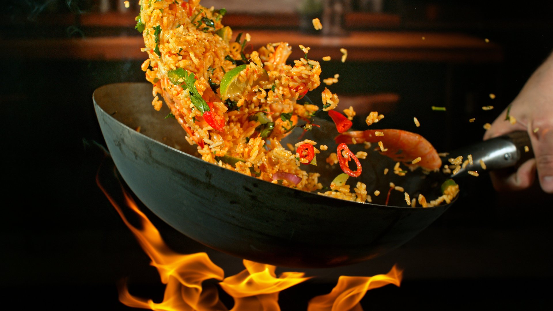 Freeze Motion of Flying Paella Wok Ingredients with Fire Flames