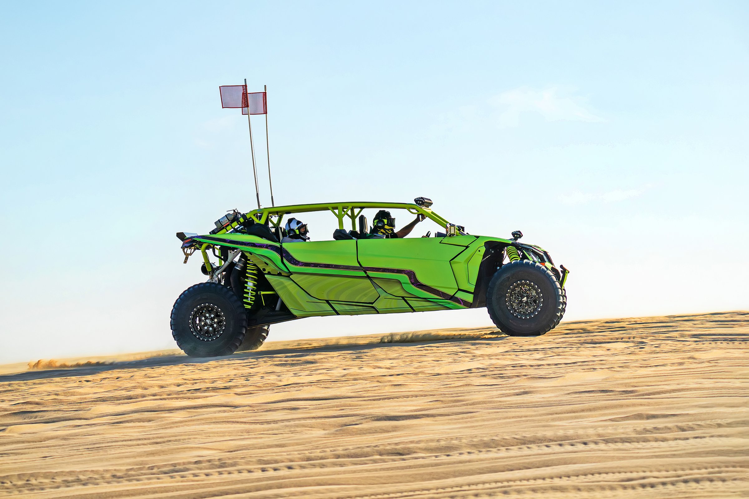 A buggy is racing at high speed over a sand dune in the desert. Arab entertainment in the desert. 4x4, travel in off-road vehicles. off road sport