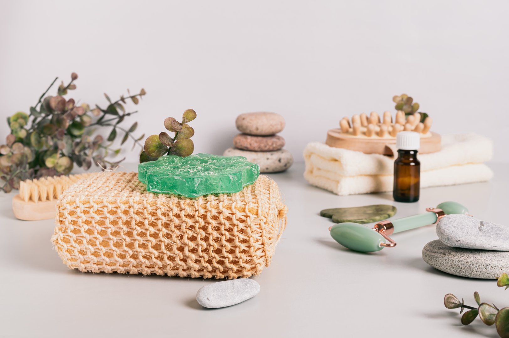Natural loofah, homemade soap and spa items on table