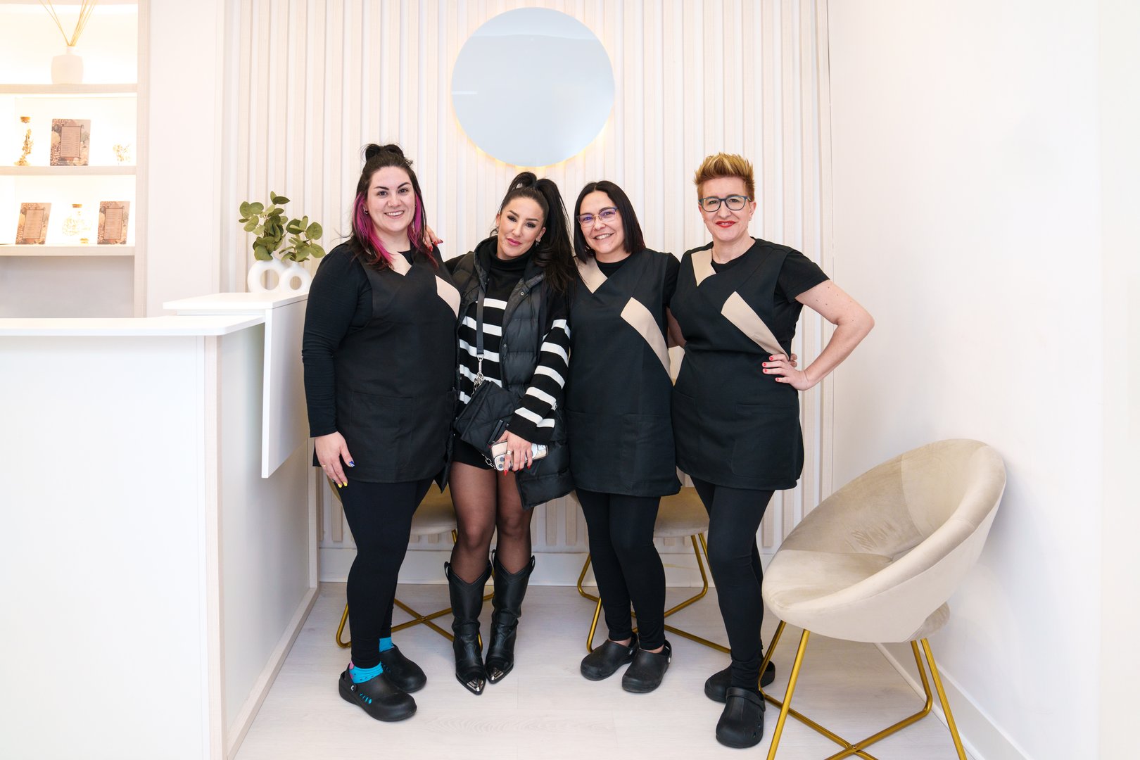 Hair clinic staff with a stylish client in modern setting.