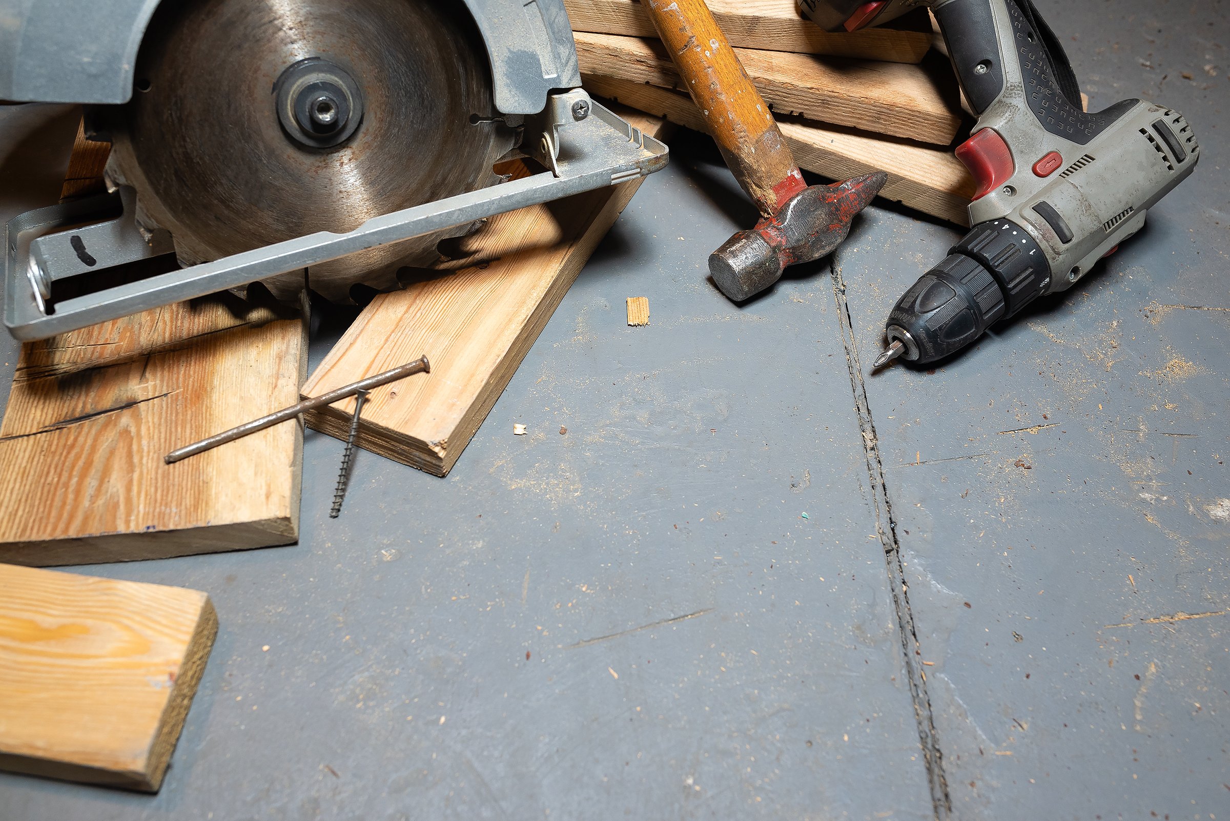 Circular saw, construction tools and wooden boards close up background. Woodwork. Construction site. Home house building.