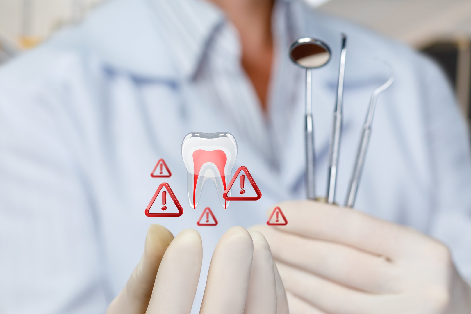 Dental warning signs. A dentist cautiously examines a tooth with warning signs.