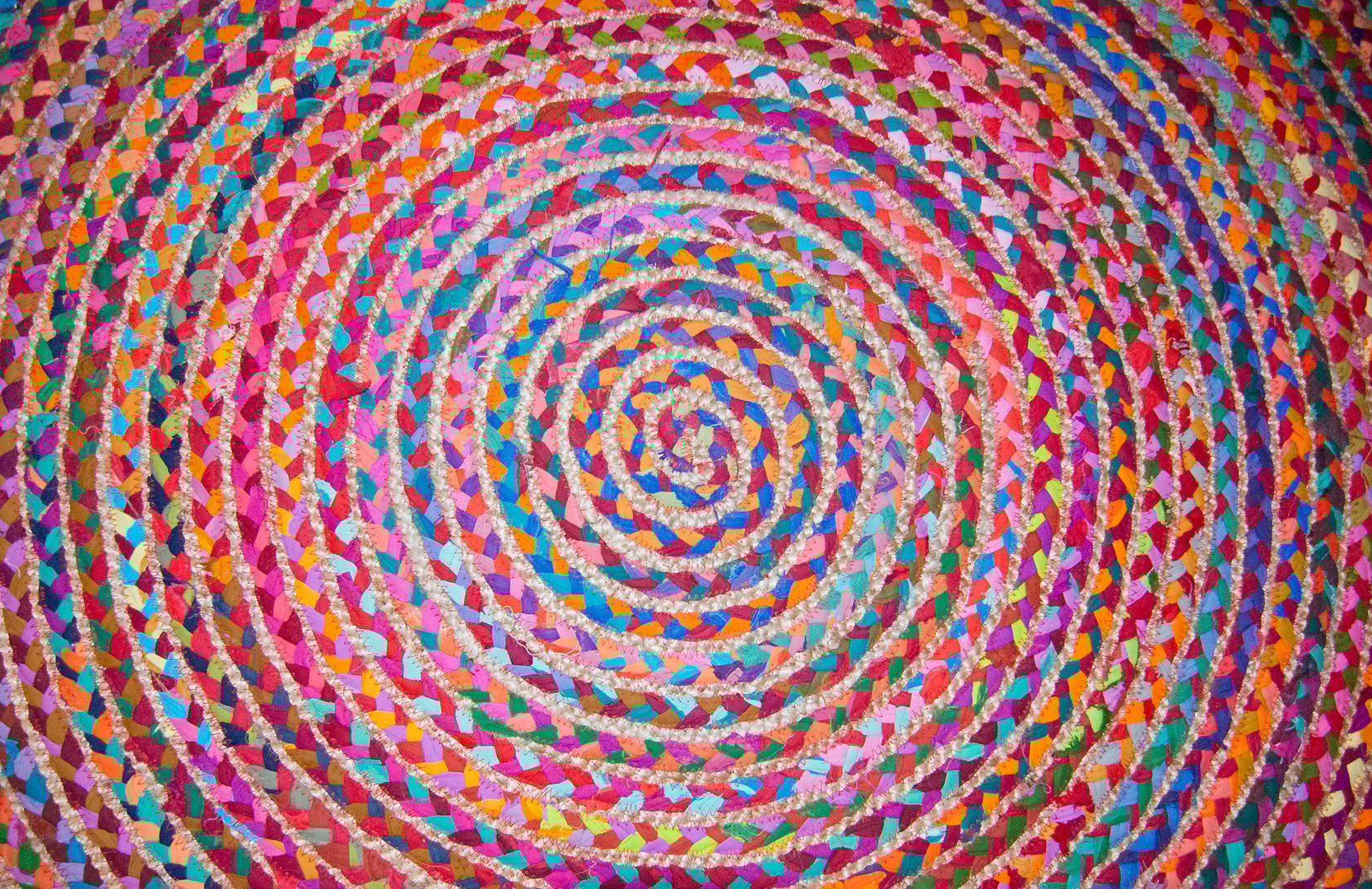 Colorful circular round fabric woven carpet pattern background.