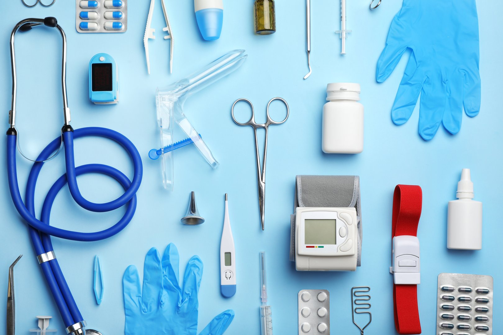 Medical Equipment Flat Lay on Blue Background.