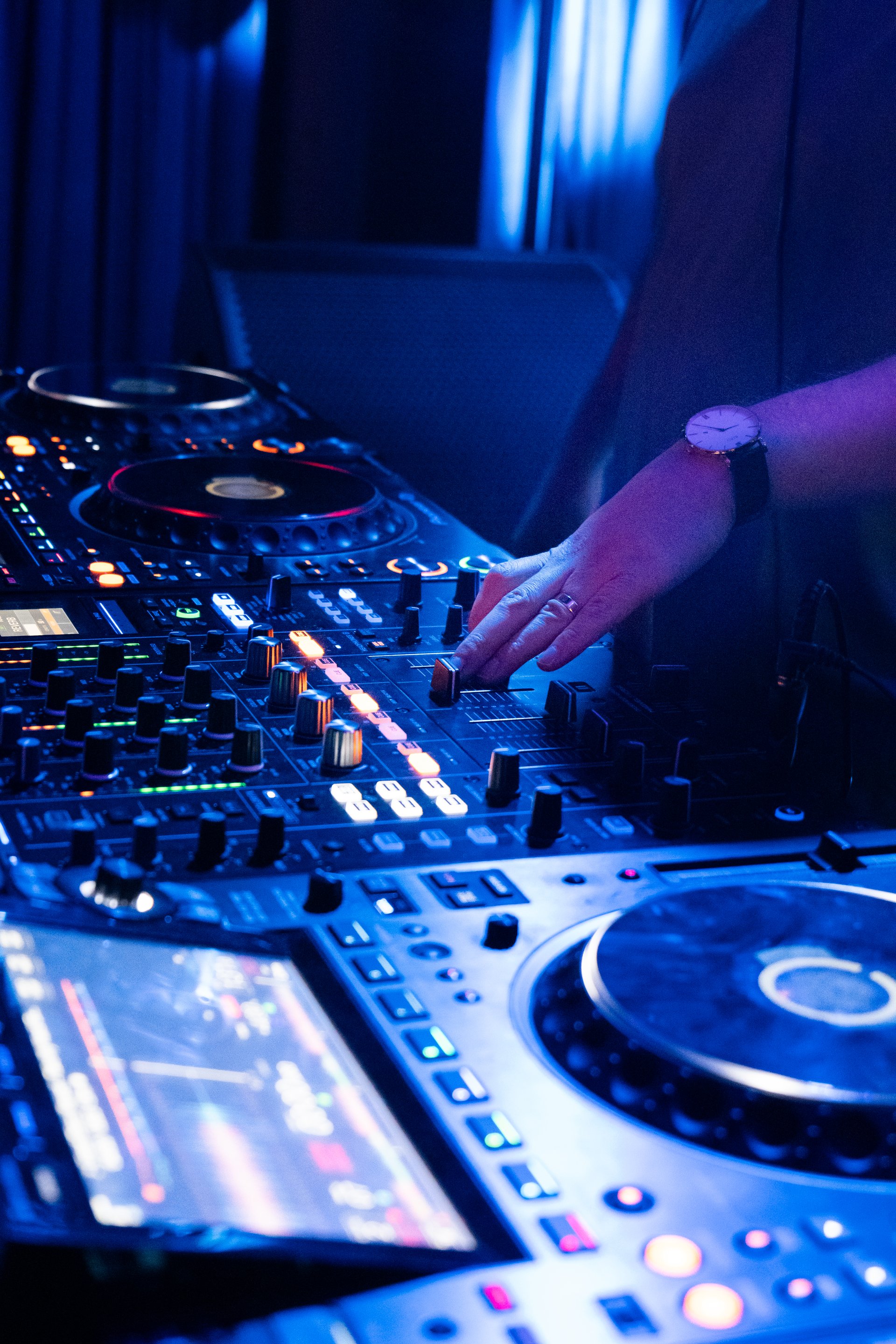 DJ adjusting music mix on professional controller console