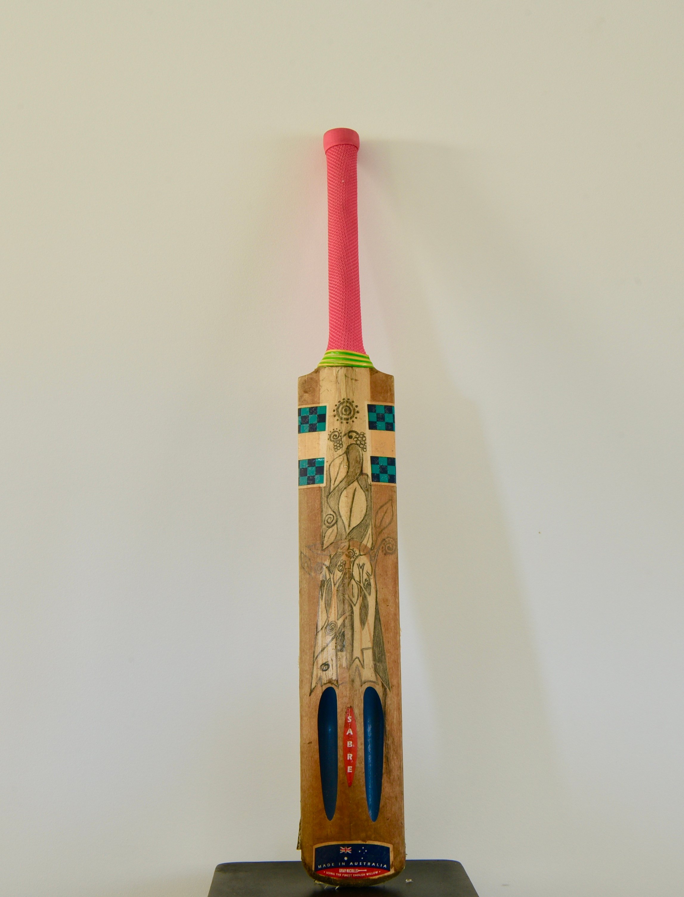Photo of a Cricket Bat with art work & painting.