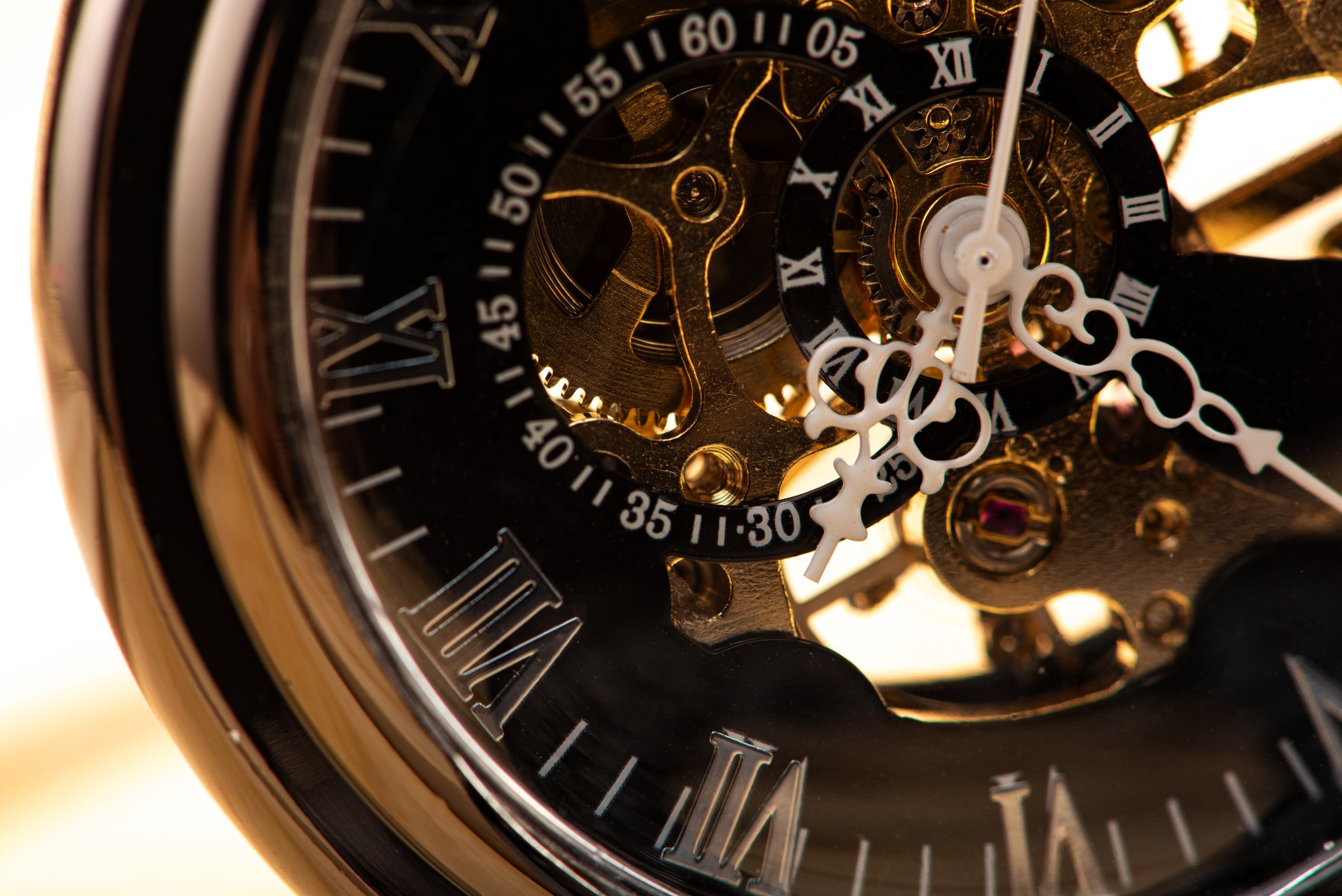 Vintage pocket watch in detail on rustic wood, selective focus.
