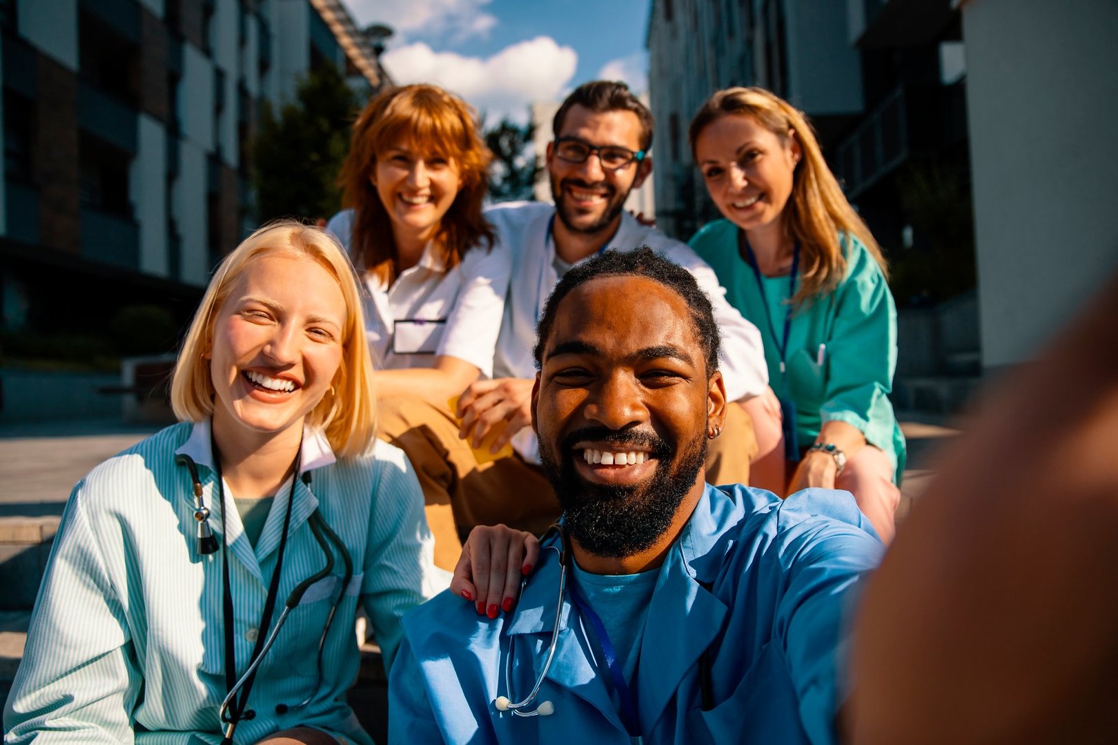 Close up of Diverse medicine students in uniform taking selfie in front of Hospital
