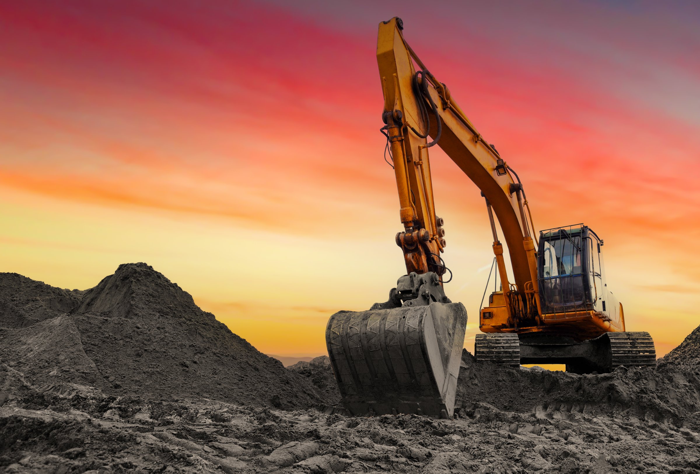 Coal mining in an open-pit. Excavator on Coal mining. Excavator digging in open pit coal mine. Excavator in open-pit on sunset background. Heavy machinery in opencast. Earthmover on earthmoving