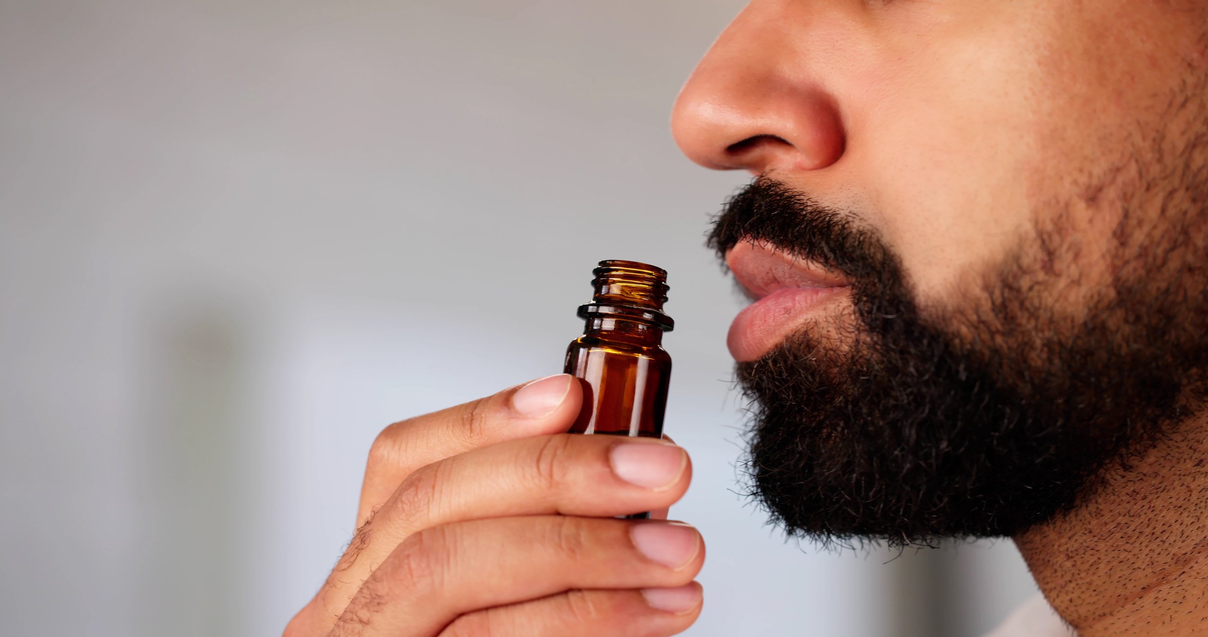 The Herbalist: African American Man Embracing Aromatherapy Oil Inhalation