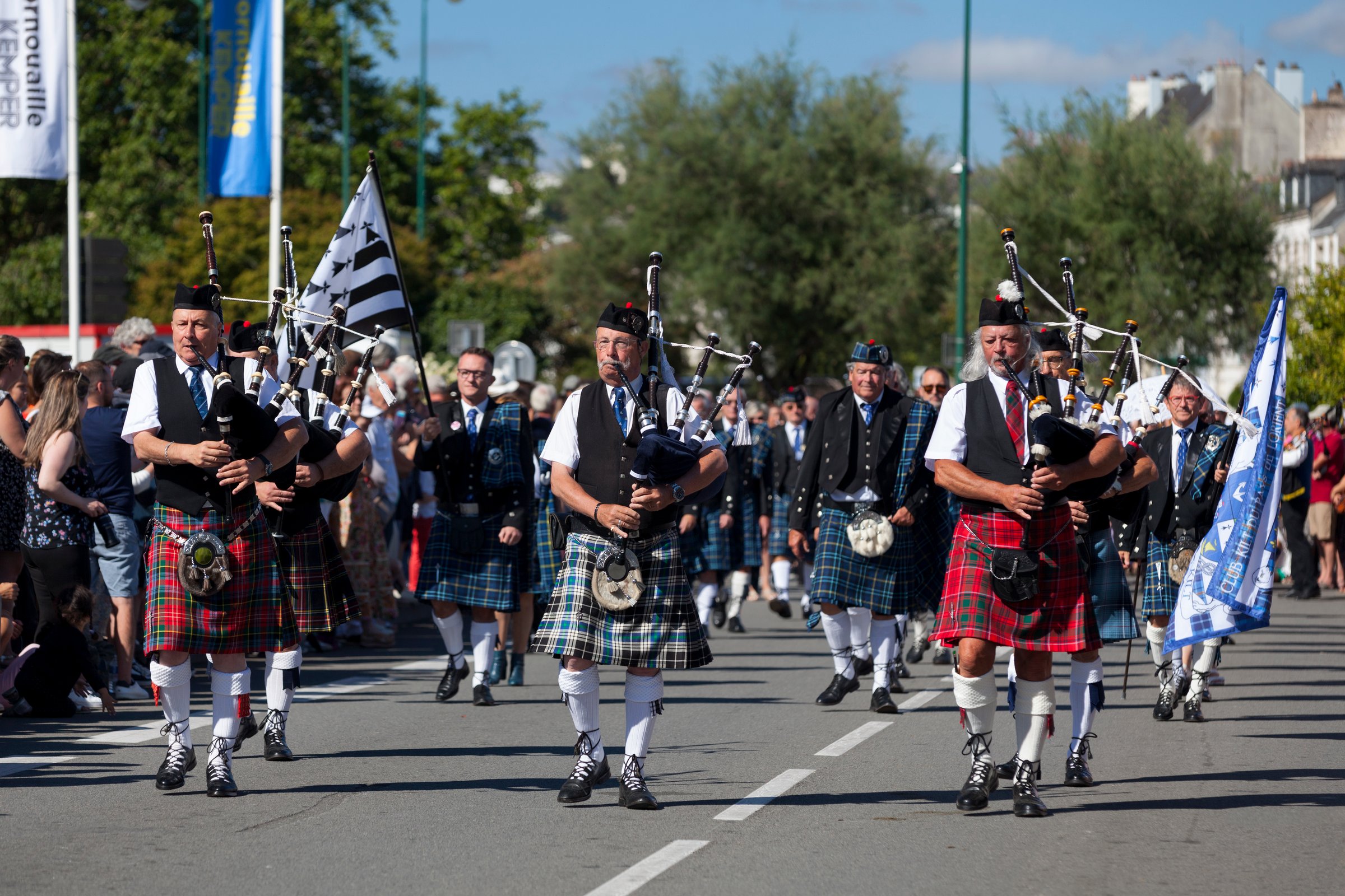 Quimper, France - July 24 2022: Musicians of the Club kilt du Pays de Lorient performing during the Cornouaille festival.