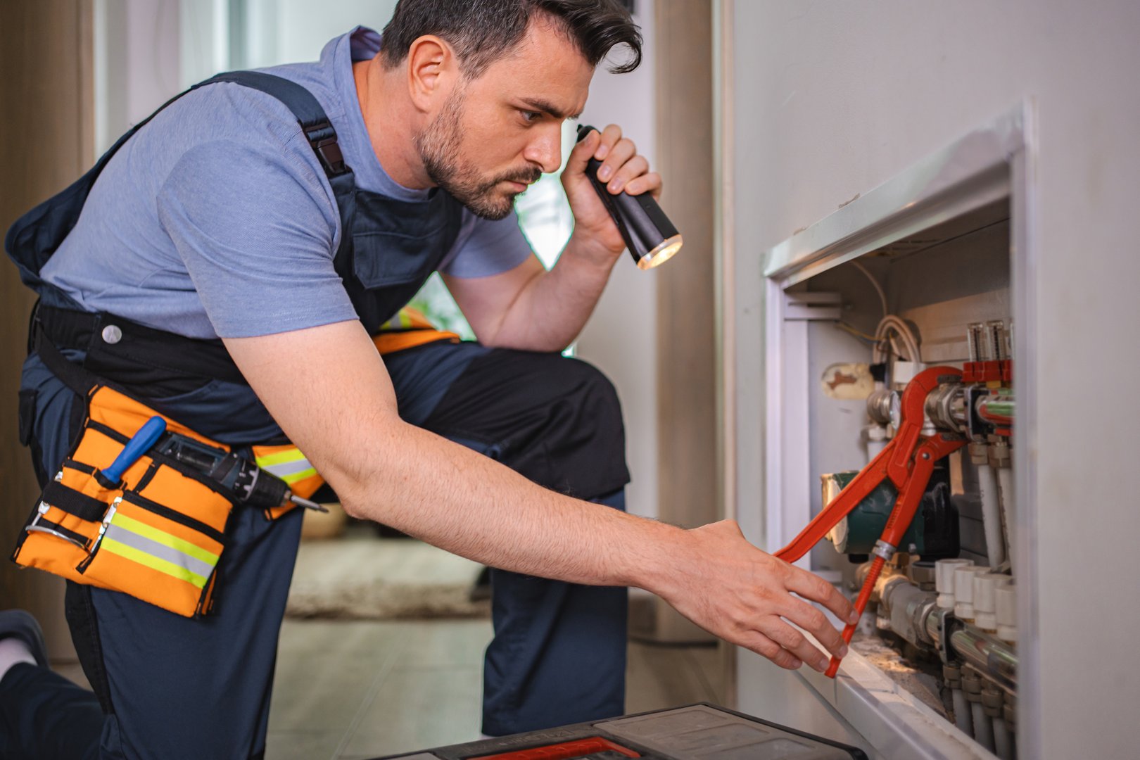 Plumber inspecting plumbing