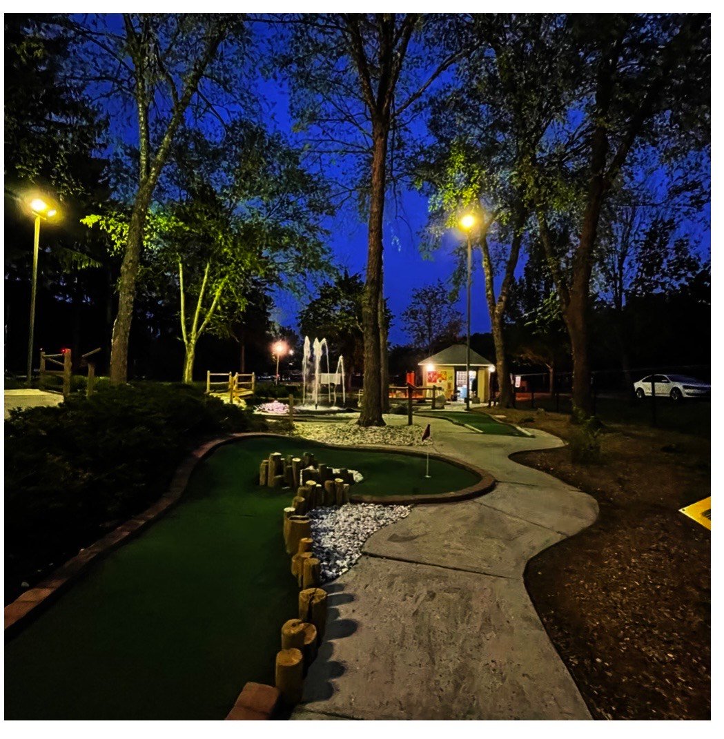 Scenic pathway through Saxon Woods Mini Golf course with natural landscaping