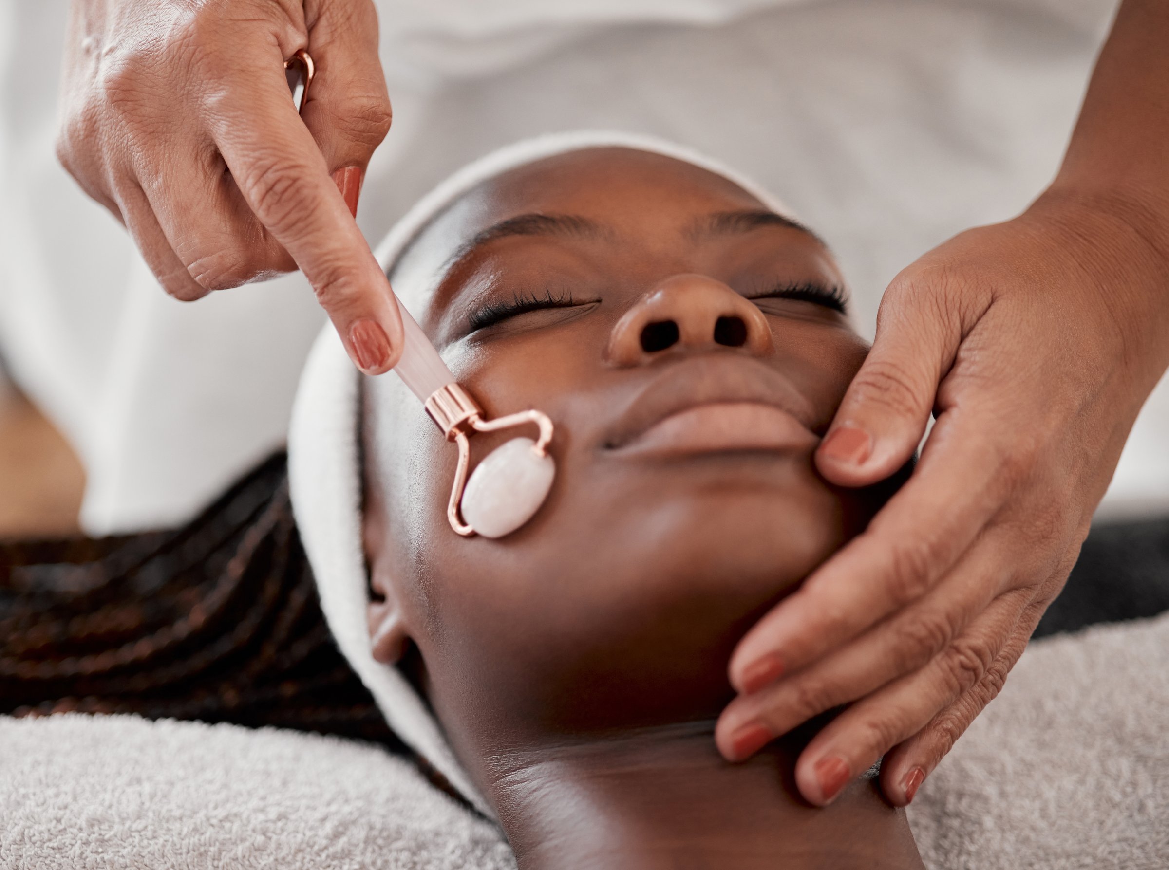 Facial roller spa and black woman relax for massage