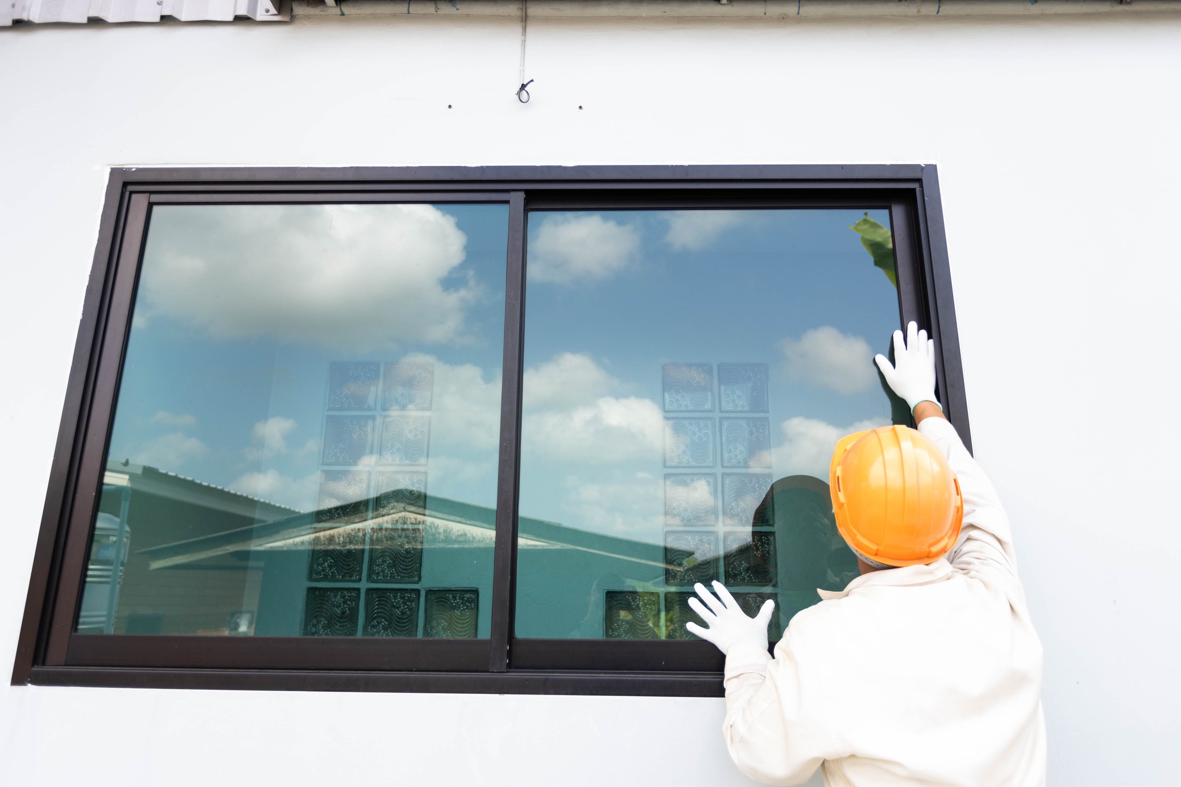 The glazier is about to install an aluminum-glass window.