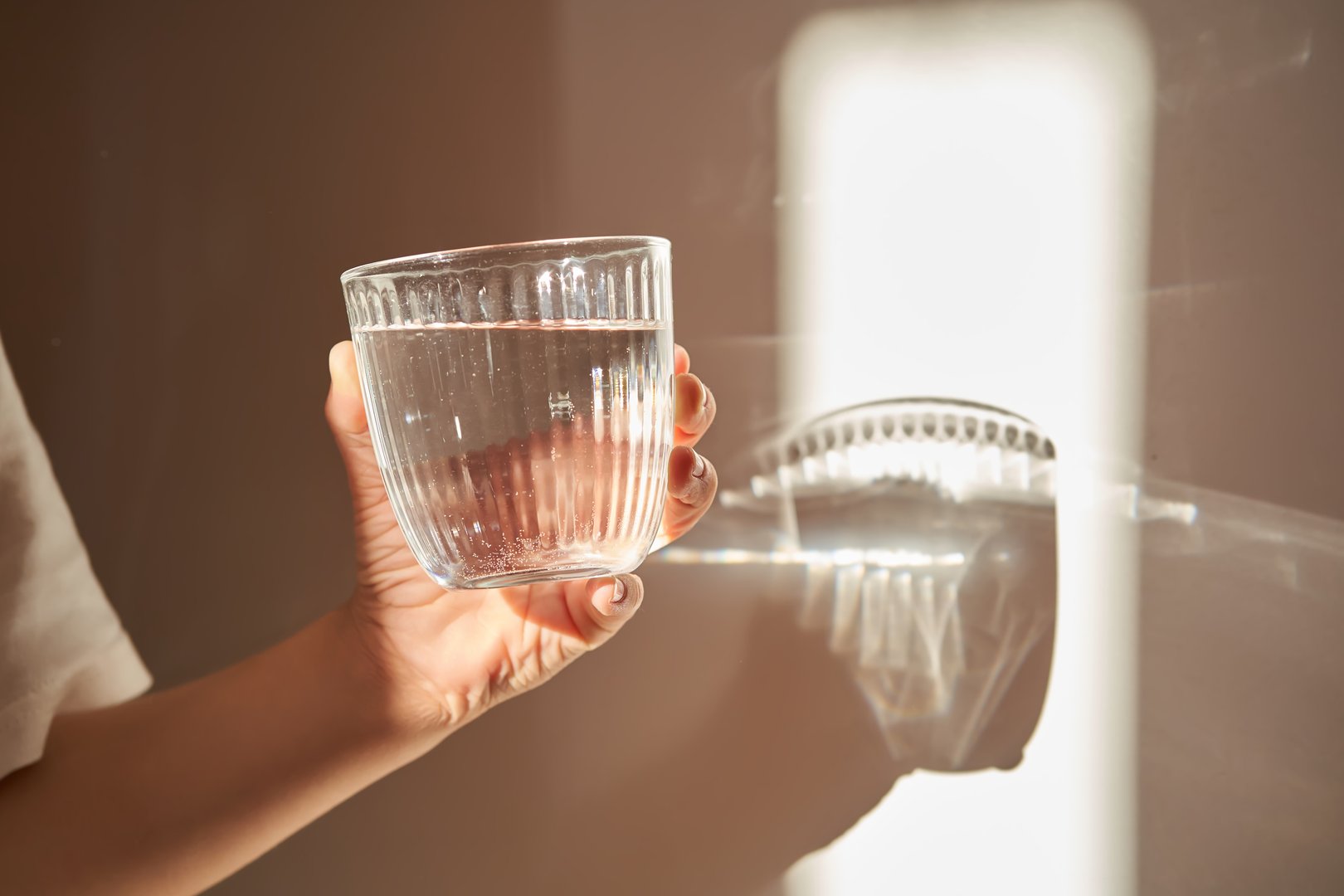 A glass of clean filtered drinking water in the morning sun.
