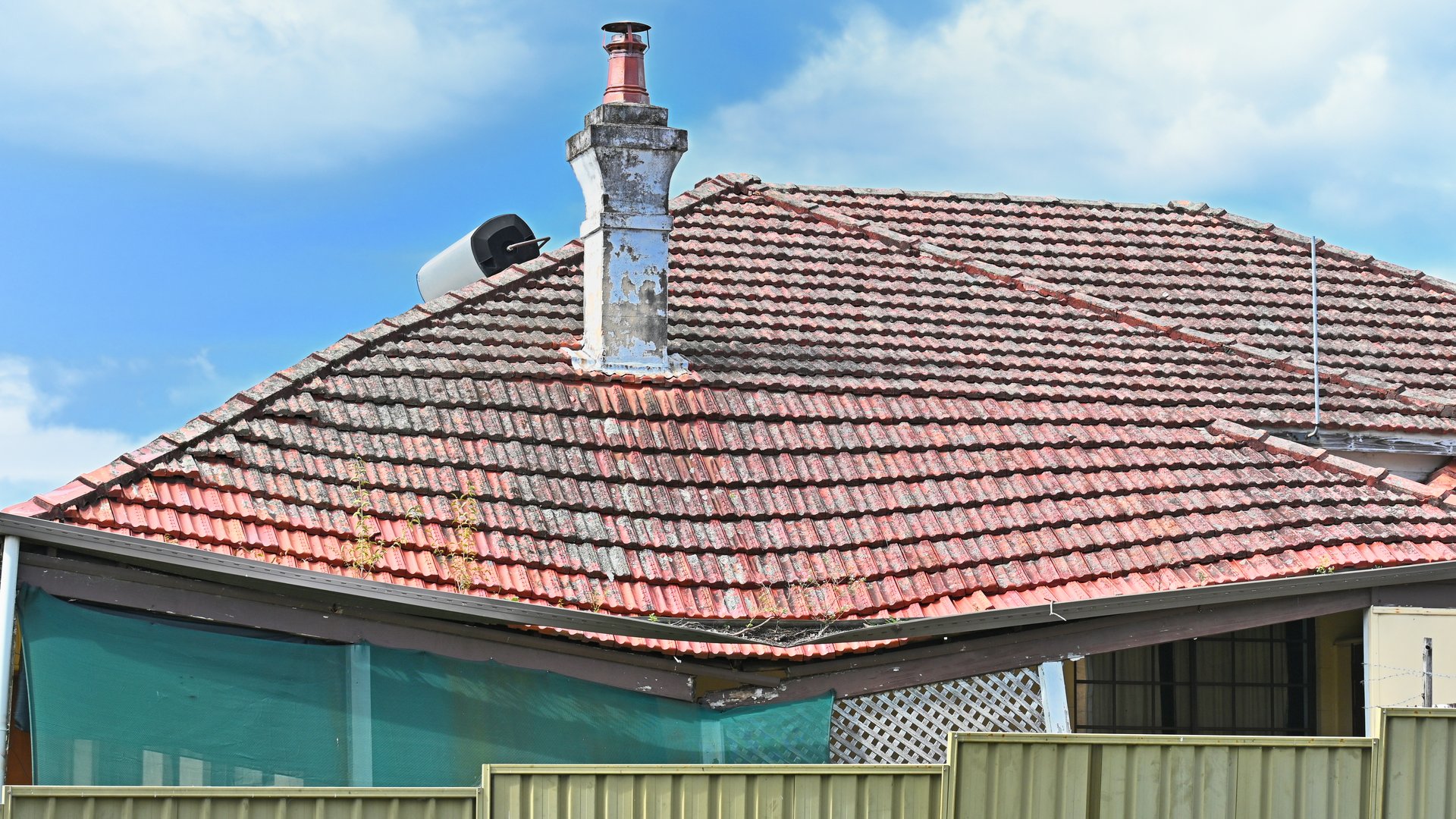Tiled roof on an old house that has collapsed due to white ant infestation